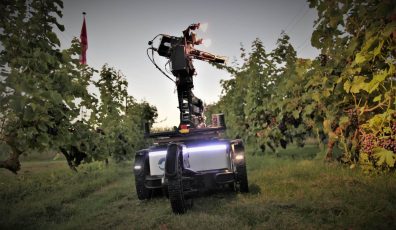 Hyperspectral camera mounted on autonomous robot driving between field with grapes