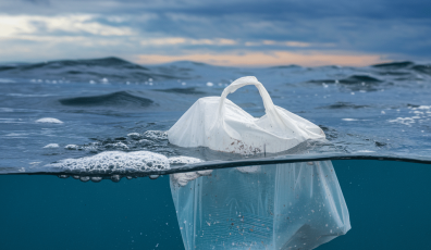 Plastic bag floating in the ocean together with other plastics creating micro- and nanoplastic polution